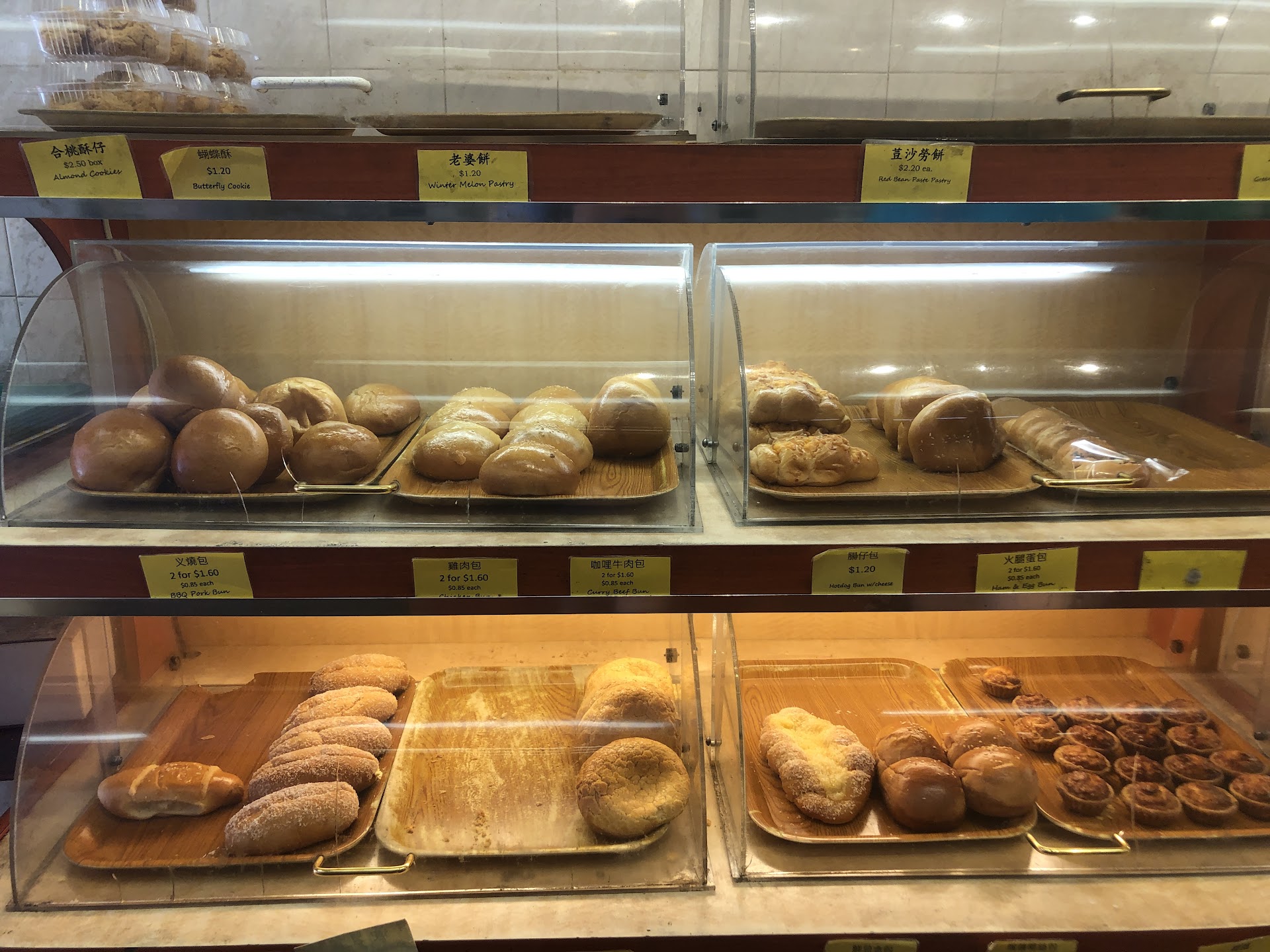 Display case filled with steamed buns and pastries