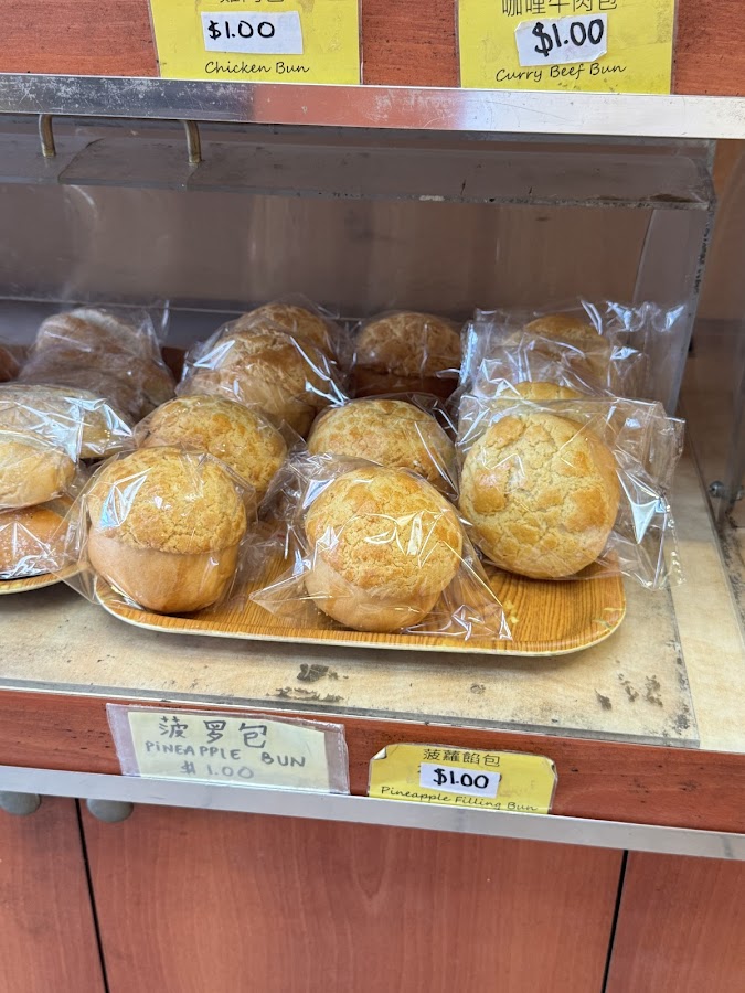 Packaged pineapple buns in bakery display